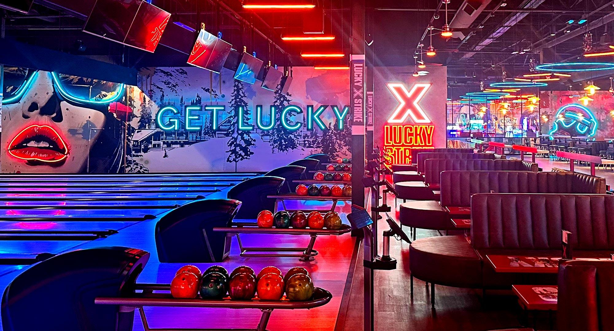 Colorfully lit bowling lanes and large, cushioned booths