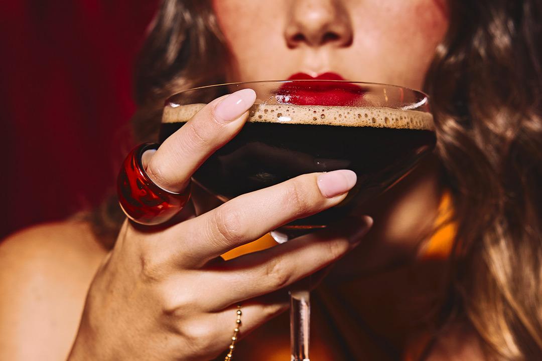 Girl holding an espresso martini. 