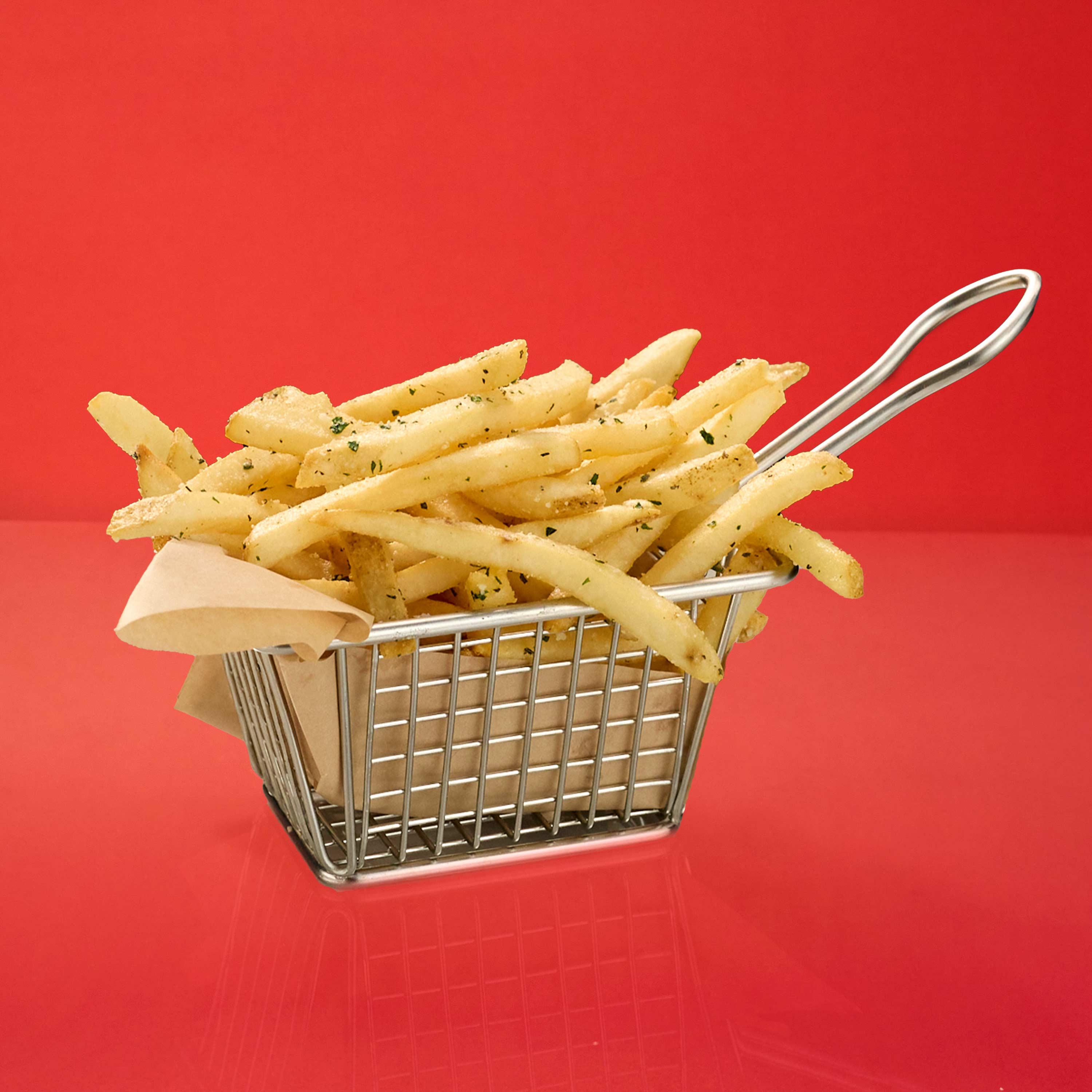 Basket of fresh herb truffle fries with rosemary, thyme, parsley, parmesan, and truffle oil.