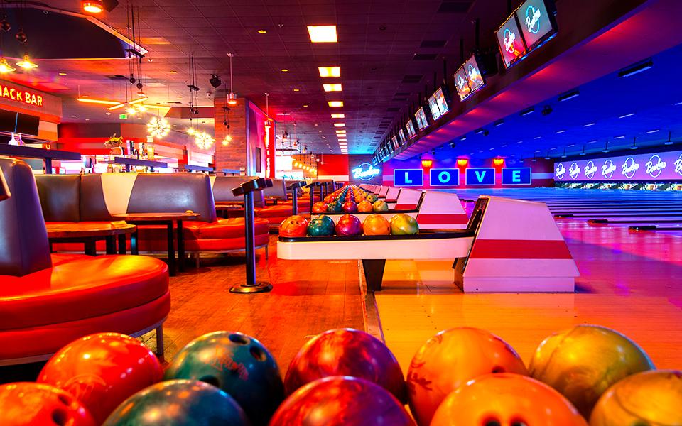 Bowling ball return with bowling center in the background