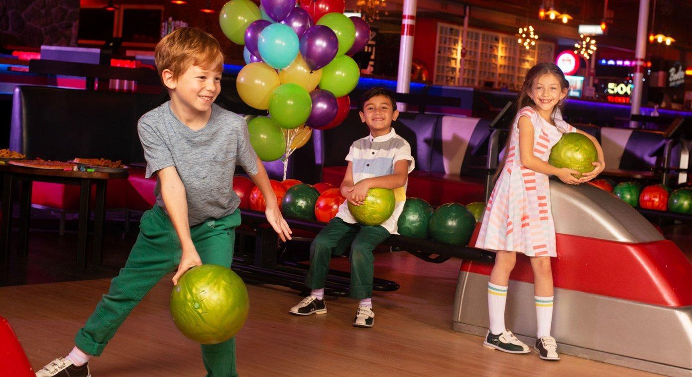 Kids having fun and bowling