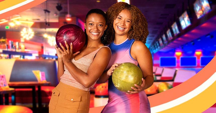 Two bowlers having fun with bowling lanes in the background