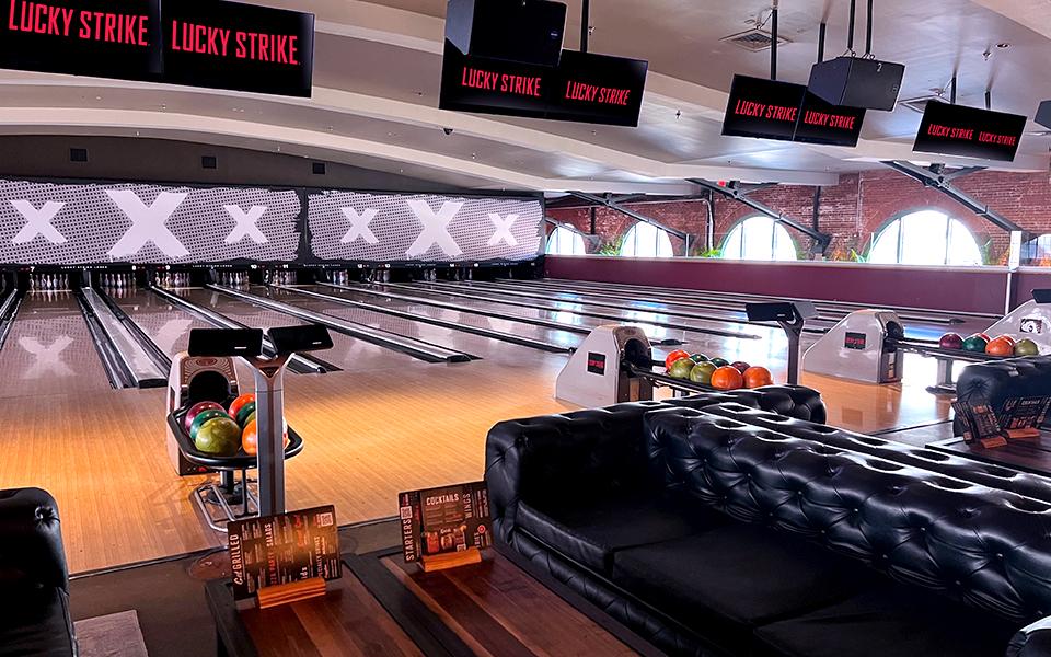 Well-lit bowling lanes and comfortable couches