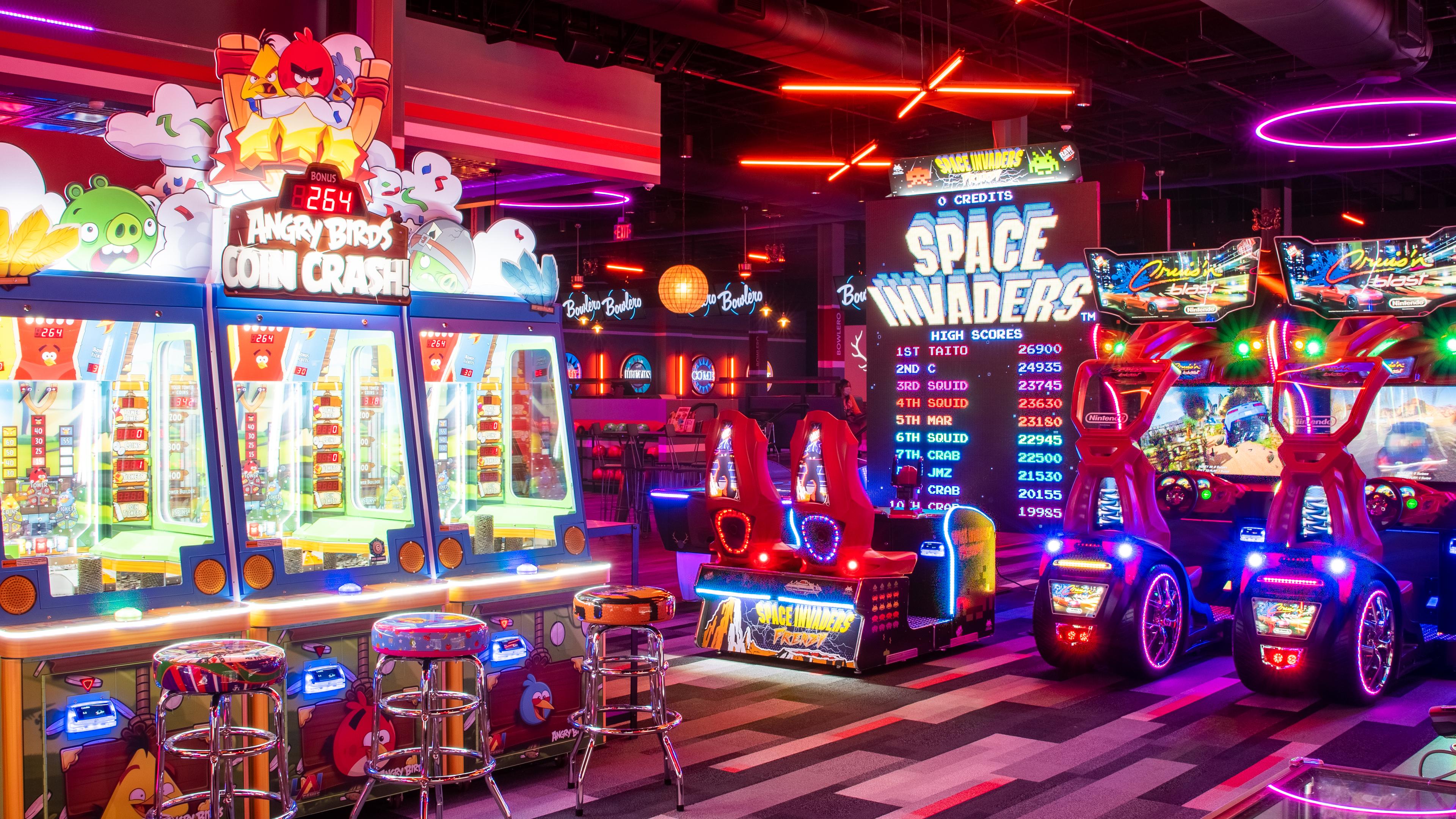 A bowlero arcade featuring space invaders and coin crashers. 