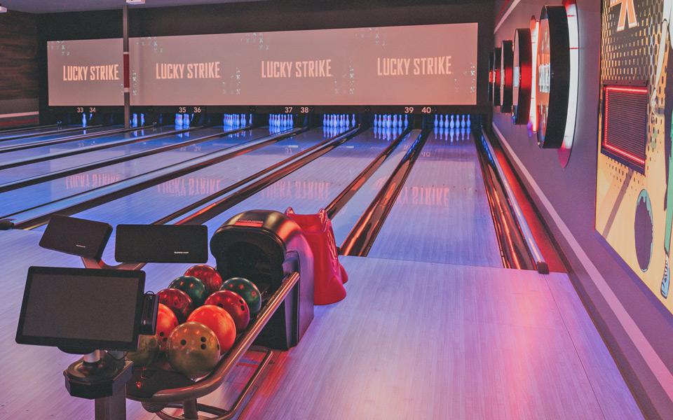 Bowling ball return with bowling lanes in the background