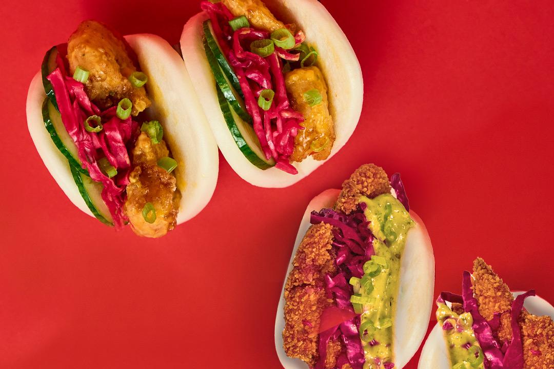 Bao buns on a red background.