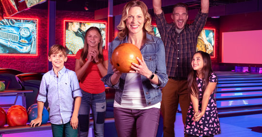 Mother and family bowling together